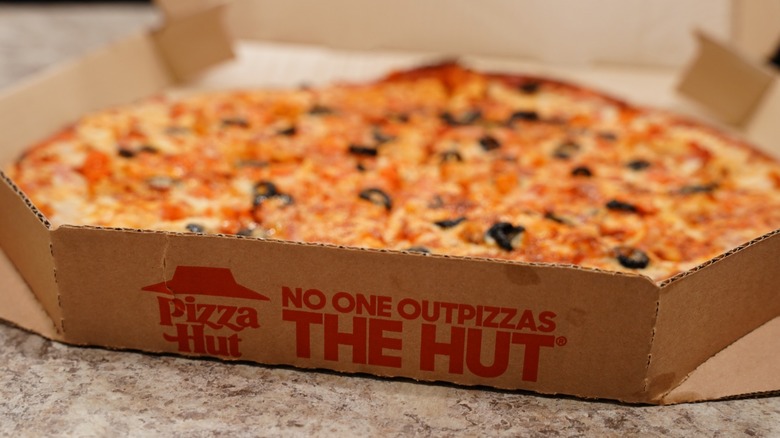 pizza hut branded box with pizza inside