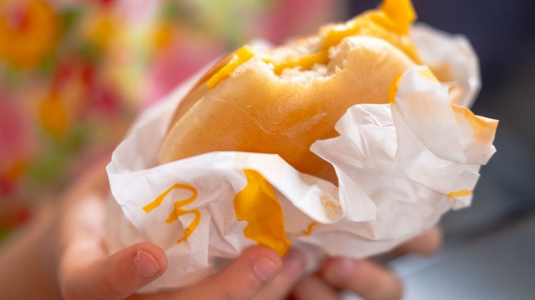 hand holds a mcdonald's bagel sandwich