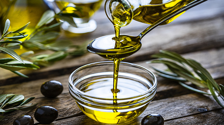 Drizzling olive oil into a bowl