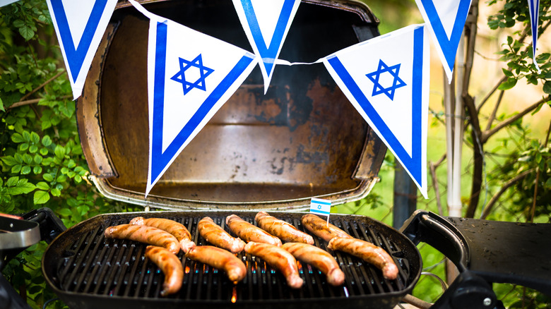 banner of Star of David above grill with sausages