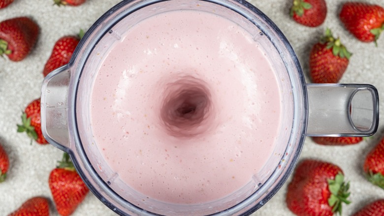 A strawberry milkshake in a blender