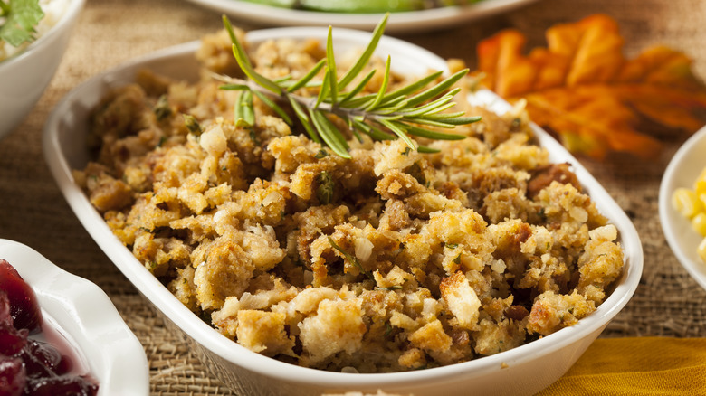 A dish of homemade Thanksgiving stuffing garnished with herbs
