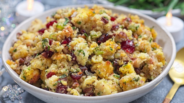 A dish of homemade Thanksgiving stuffing with cranberries and herbs