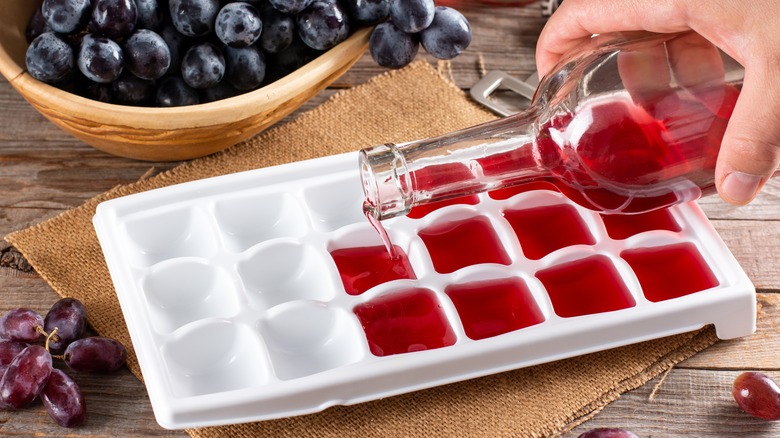 Pouring red wine into an ice cube tray