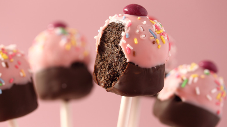 Chocolate cupcake pops on a pink background