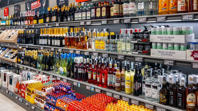 Many shelved bottles in liquor section of Italian Aldi store