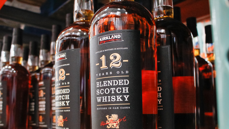 Close-up of bottles of 12-year-old Kirkland Blended Scotch Whisky on shelf.