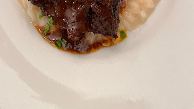 Short ribs on bed of risottot garnished with chopped chives
