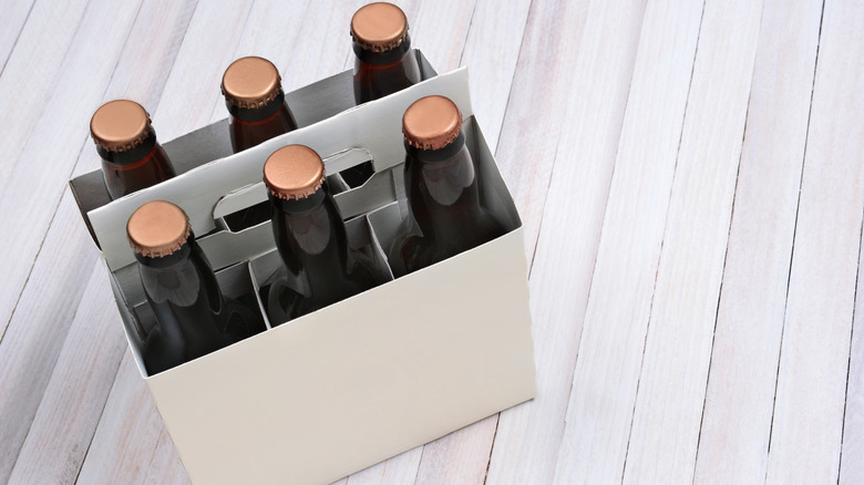 A white six pack of beer bottles on a table