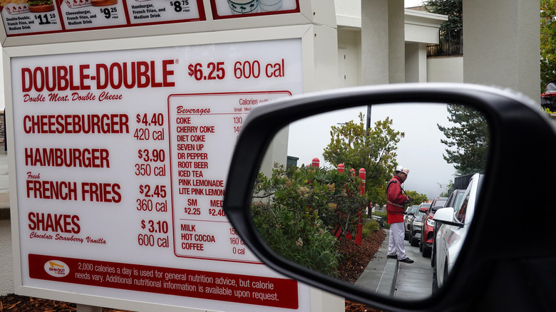 In-N-Out menu and car's rearview mirror