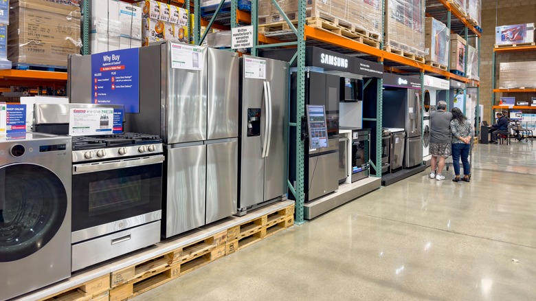 A variety of appliances on display inside a Costco store.