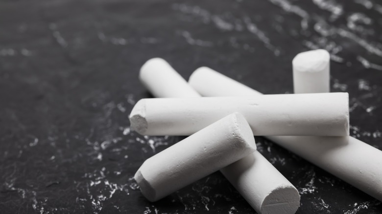 white sidewalk chalk on slate background