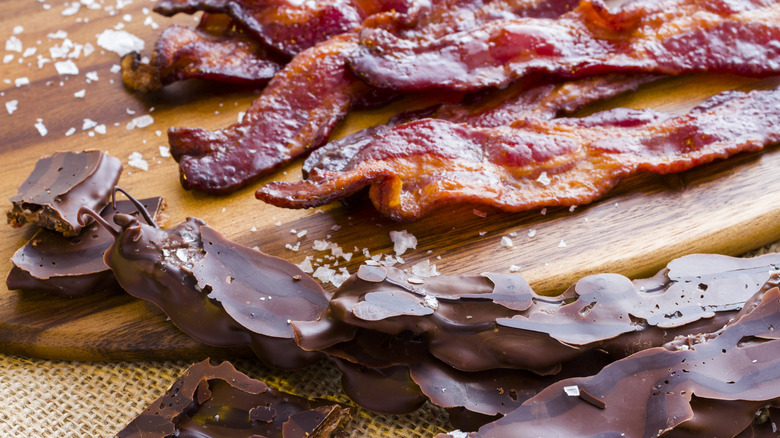 A close-up of chocolate-covered bacon beside regular bacon