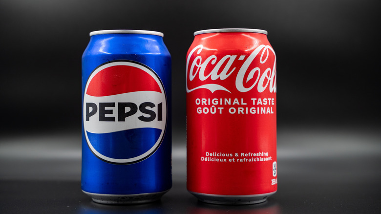 cans of coke and pepsi side by side