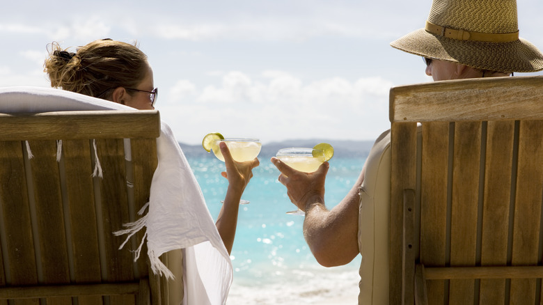 Couple enjoying margaritas on shore of beach