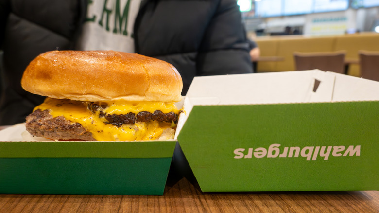 Wahlburger cheeseburger in green branded box, closeup