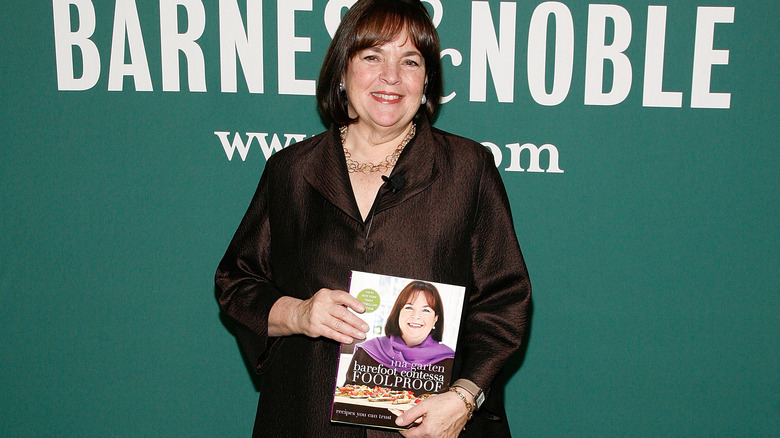 Ina garten holding one of her cookbooks