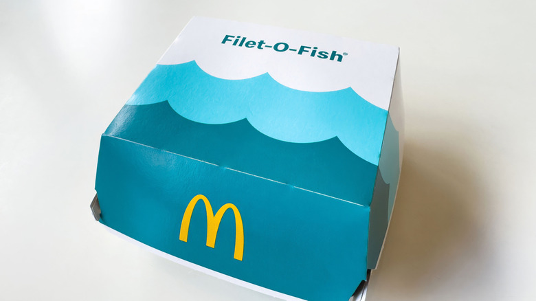 A clamshell box holds a McDonald's Filet-O-Fish sandwich