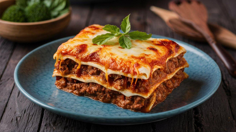 A plate of fancy lasagna topped with some kind of herb