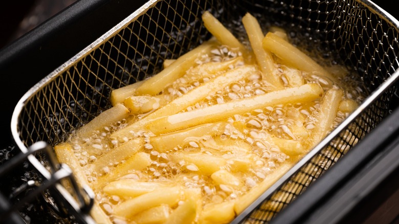 french fries cook in basket fryer