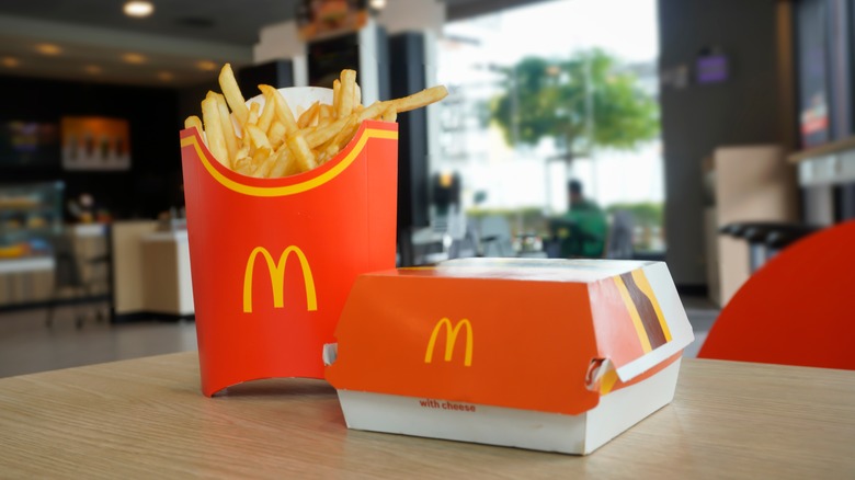 A McDonald's hamburger box and an order of fries