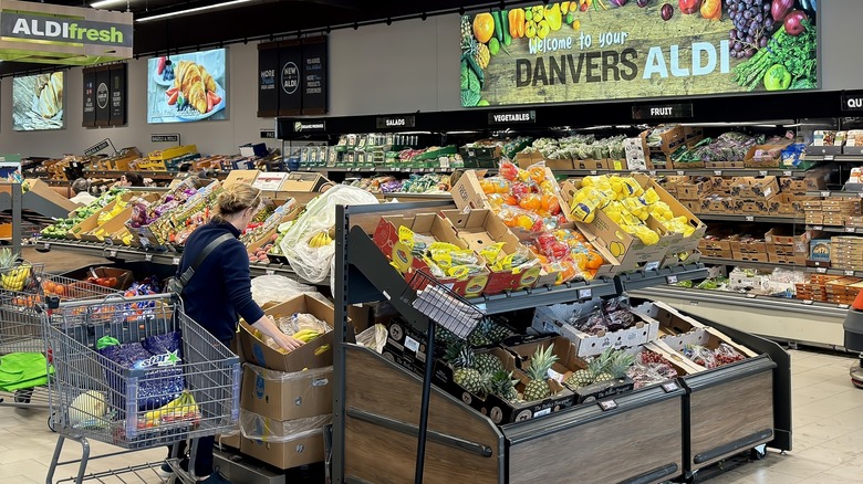 Aldi produce section with shopper.