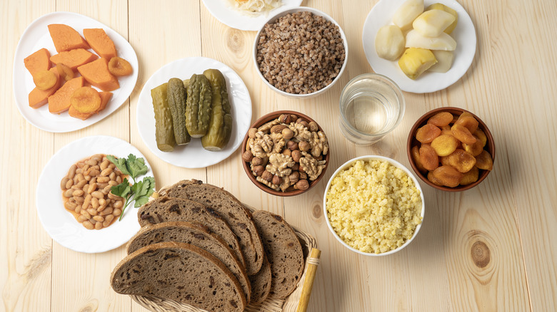 Various Lent season dishes like bread, beans, roasted vegetables, and nuts