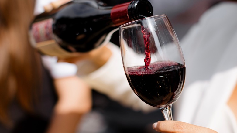 red wine being poured from bottle