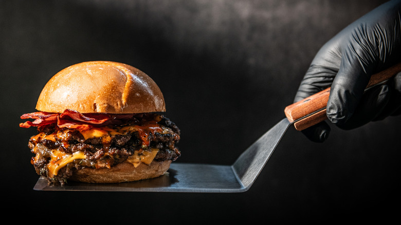 A gourmet burger on a spatula