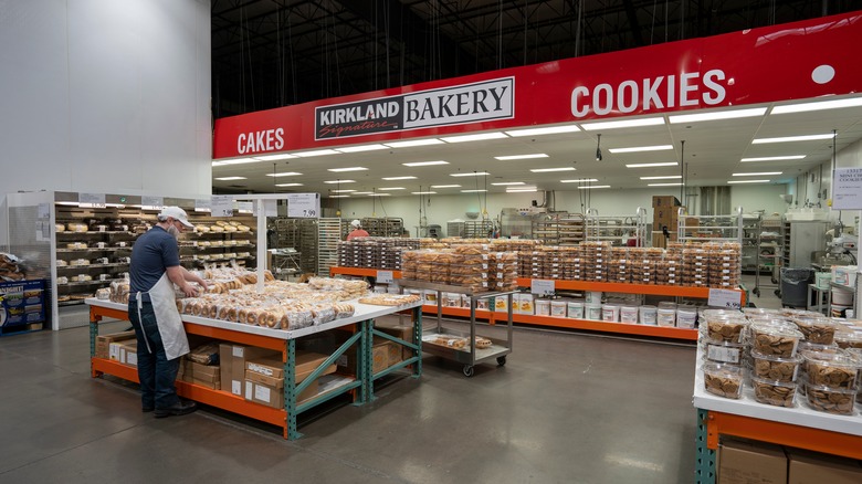 A worker displays products at a Costco bakery
