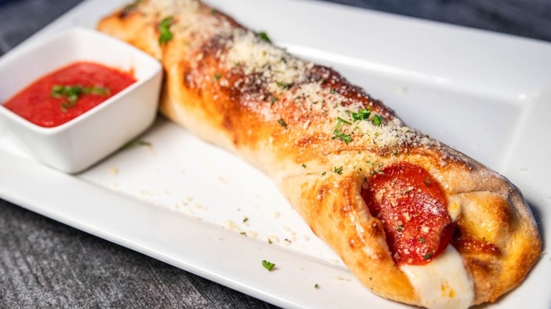 Pepperoni roll on white plate