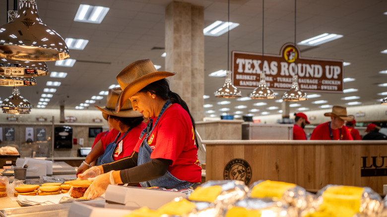 Employees prepare food at a Buc-ee's hot bar