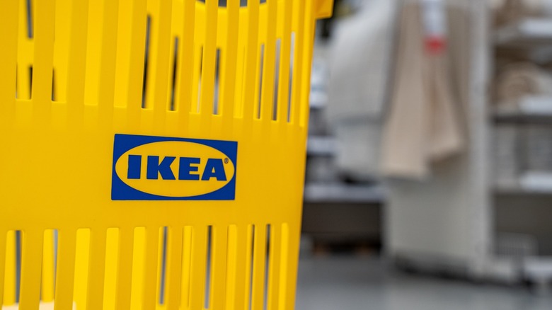 yellow ikea shopping basket with warehouse background