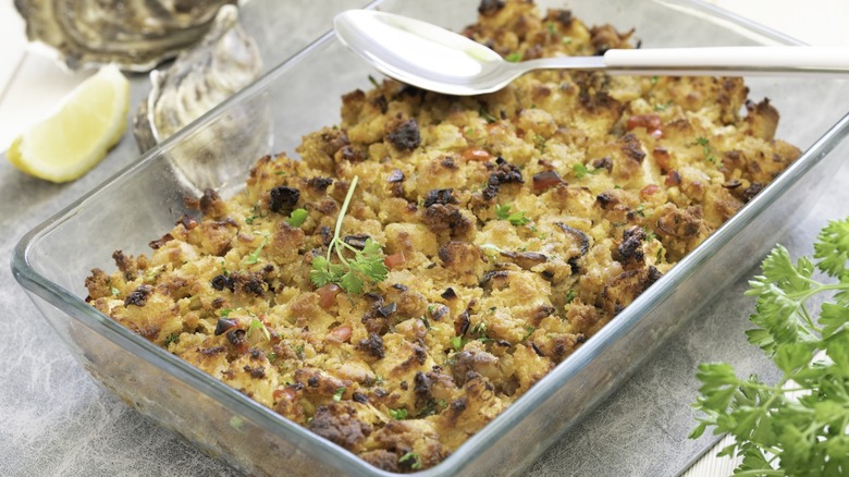 Oyster dressing with cornbread in casserole dish closeup.