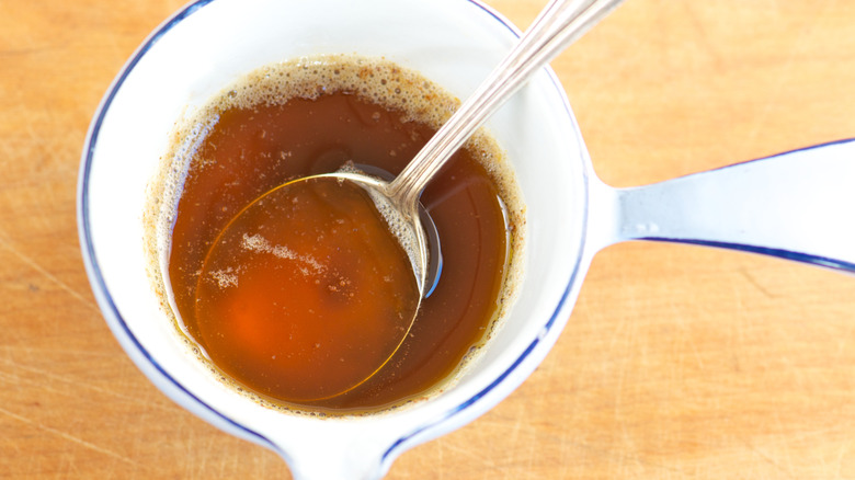 Browned butter sauce with a silver spoon from above