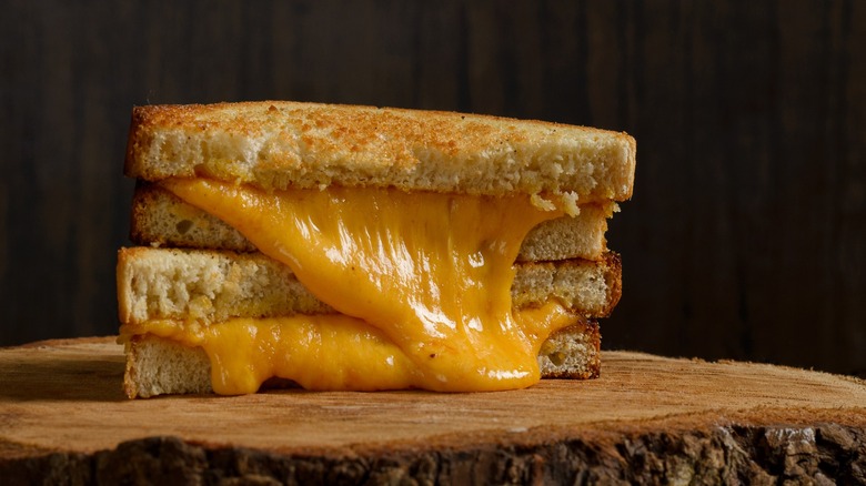 stacked grilled cheese on wooden board