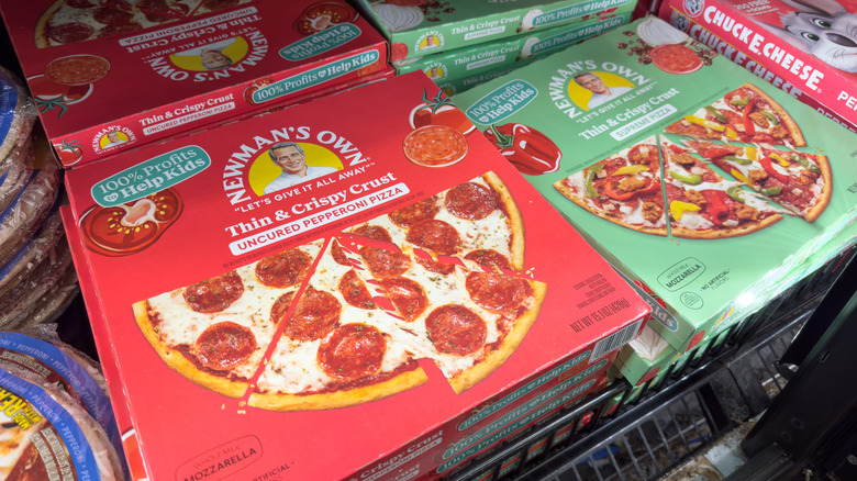 Newman's Own pepperoni and supreme pizzas in a grocery store.