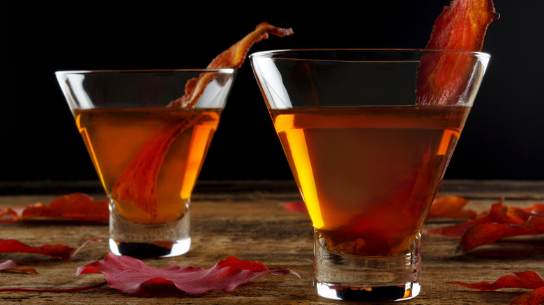 Bacon flavored bourbon shots with strips of fried bacon