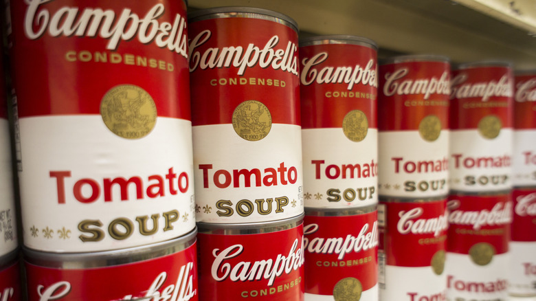 Cans of tomato soup on grocery shelf