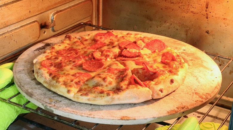 Pizza on pizza stone in conventional oven