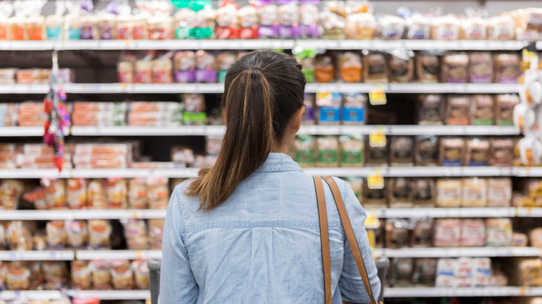 shopper looking at shelf in grocery store