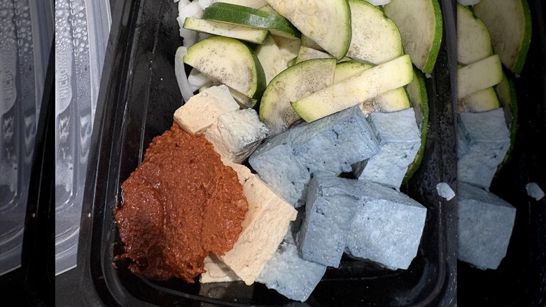 Blue tofu in a black container