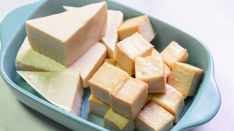 Soft tofu and fried tofu cubes in blue dish