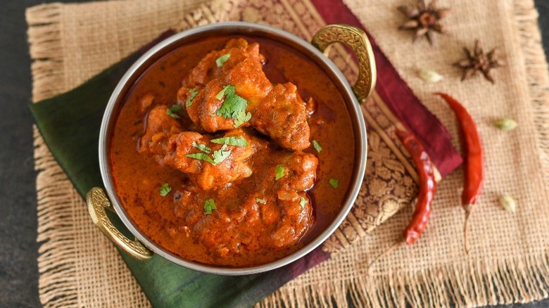 Chicken vindaloo in brass bowl. 