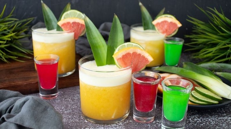 Wicked themed yellow cocktails with pink and green shooters