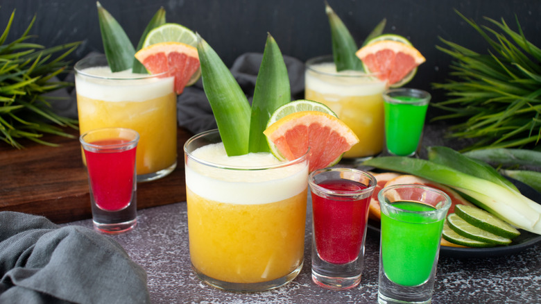 Wicked themed yellow cocktails with pink and green shooters