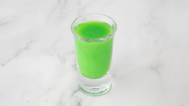 Green liquid in shot glass