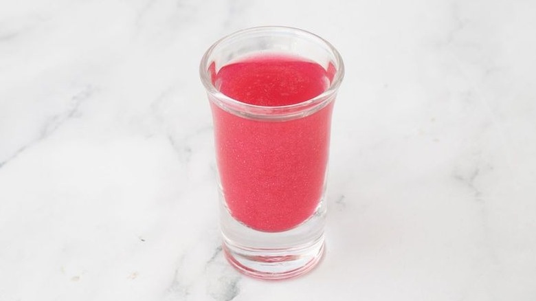 Pink liquid in shot glass