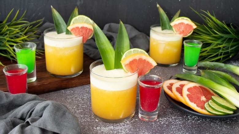 Wicked themed yellow cocktails with pink and green shooters