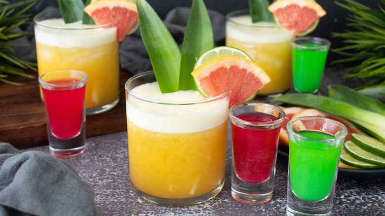 Wicked themed yellow cocktails with pink and green shooters